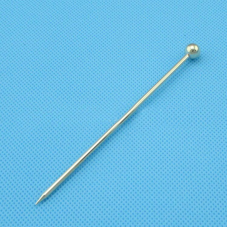 Shopi Vella shiny metal fancy cocktail picks for parties with a round ball top on blue background