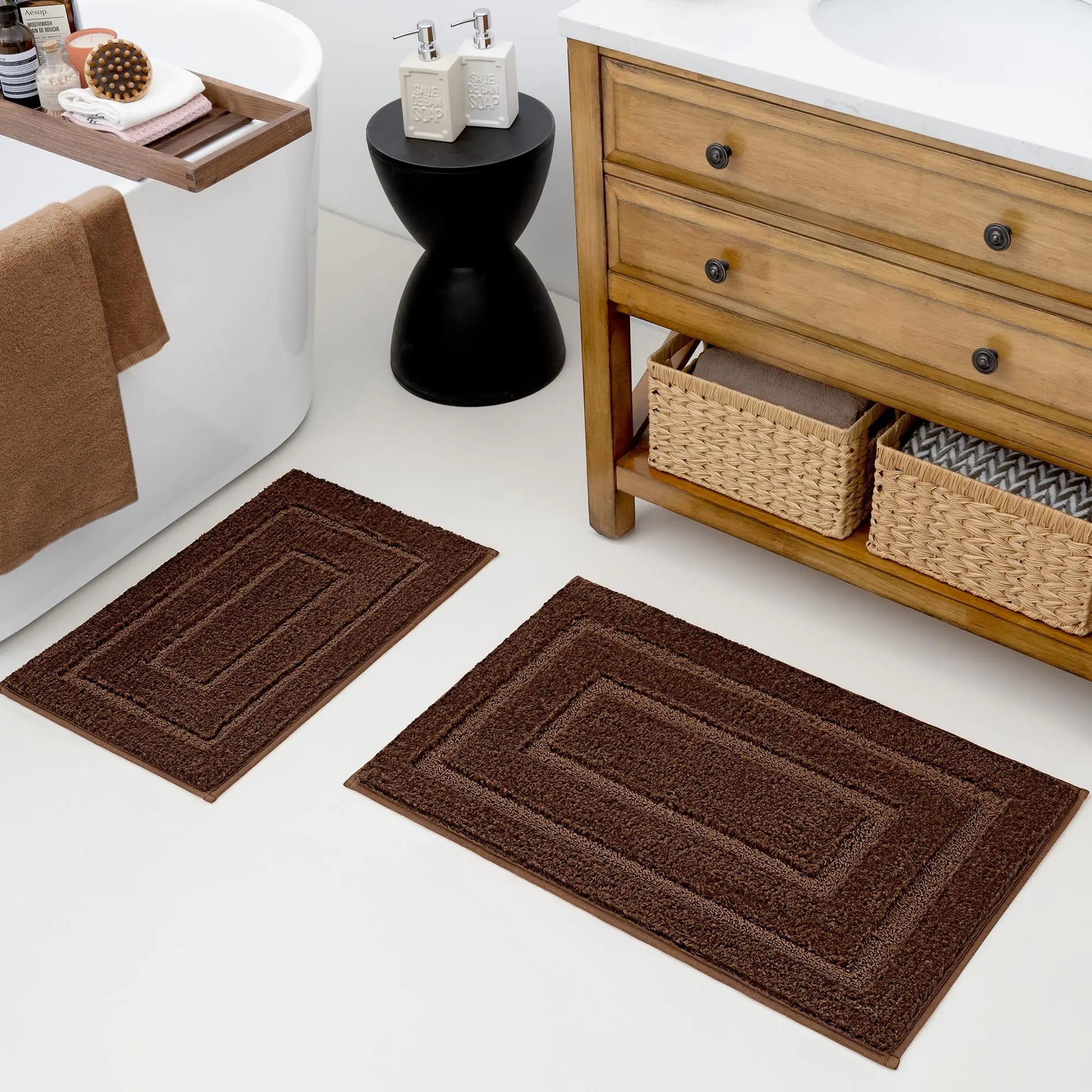Brown granny says 2 piece bathroom rug set placed on white floor in modern bathroom