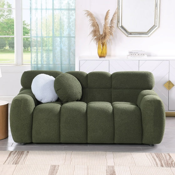 Shopi Vella green upholstered sofa with rounded cushions and modern design in bright living room