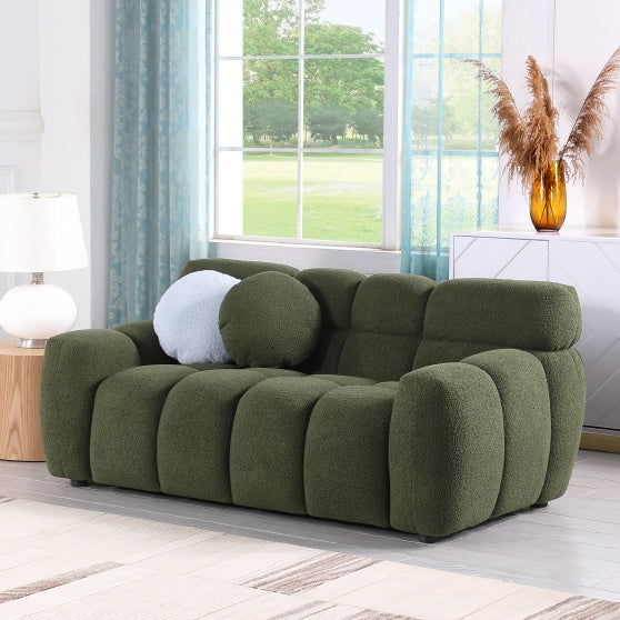 Shopi Vella green upholstered sofa with plush cushions in a bright living room setting