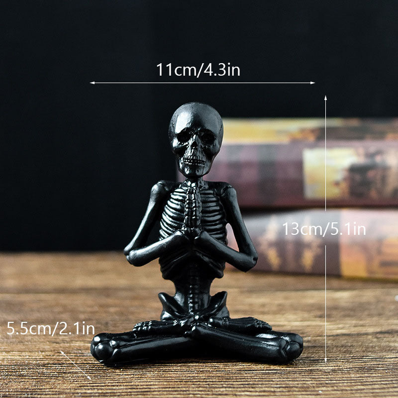 Black halloween yoga skeleton decor figurine sitting cross-legged with hands in prayer pose
