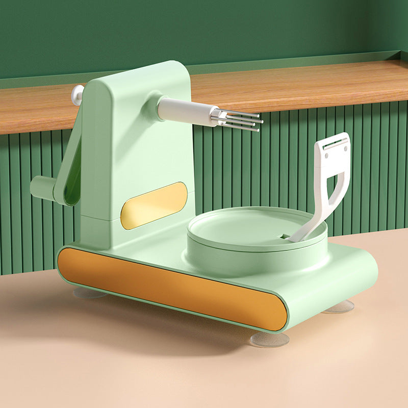 Shopi Vella hand-cranked fruit peeler machine in mint green with gold accents on kitchen countertop