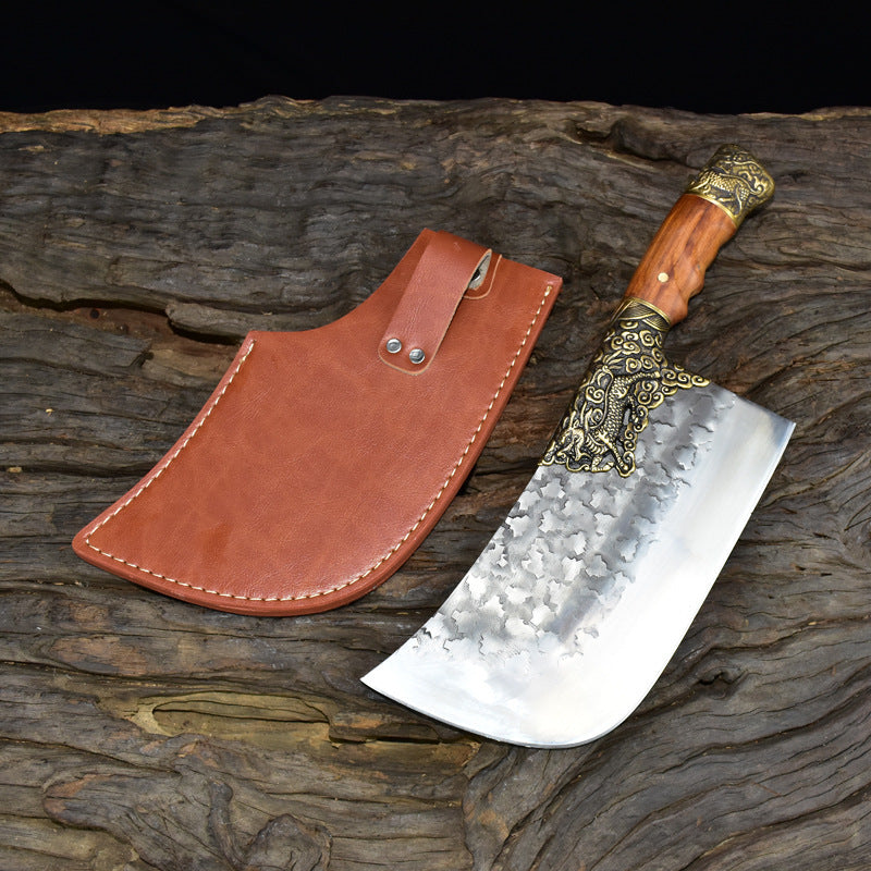 My Store hand-forged bone chopping knife with wooden handle and decorative brass details next to brown leather sheath