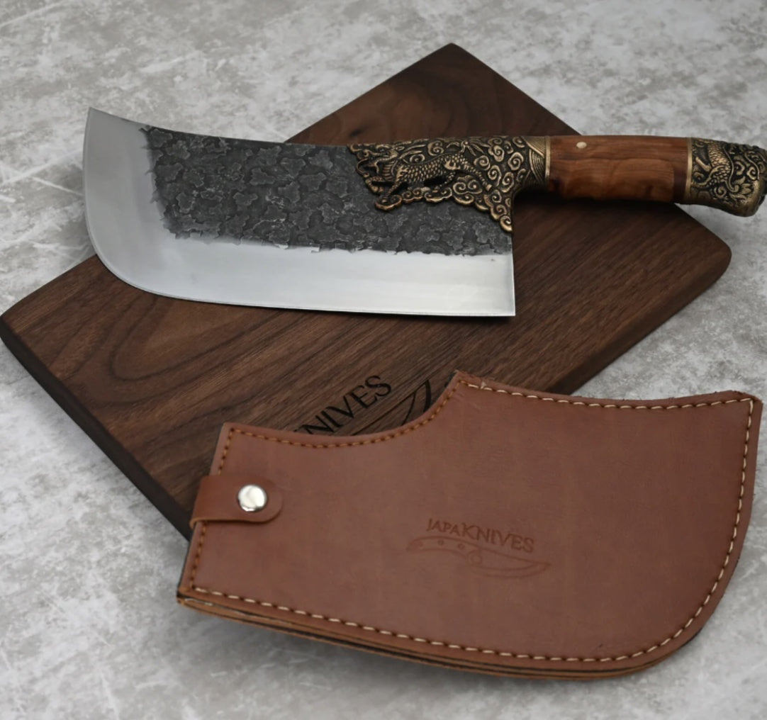 My Store hand-forged bone chopping knife with decorative handle on wooden cutting board and leather sheath