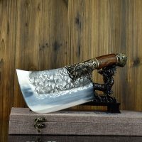 Hand-forged bone chopping knife with wooden handle displayed on decorative stand against wooden background