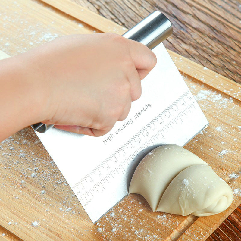 Shopi Vella pizza dough cutter tool with stainless steel blade and handle cutting dough on wooden board