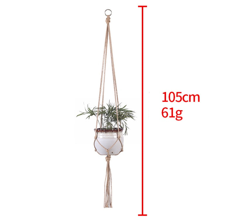Shopi Vella hand-woven hanging basket with jute rope and ceramic pot holding a green plant