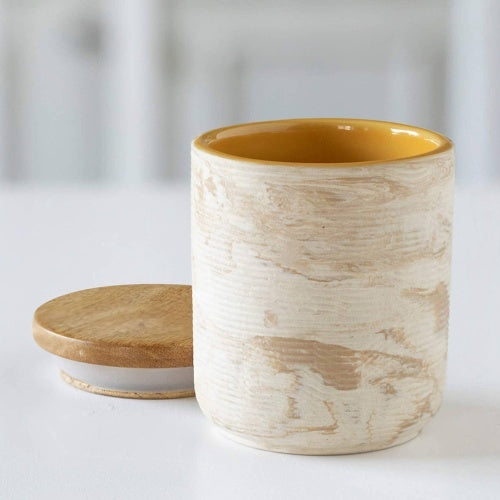 Handcrafted ceramic jar with wood lid in natural and yellow tones from Shopi Vella storage bottles and jars