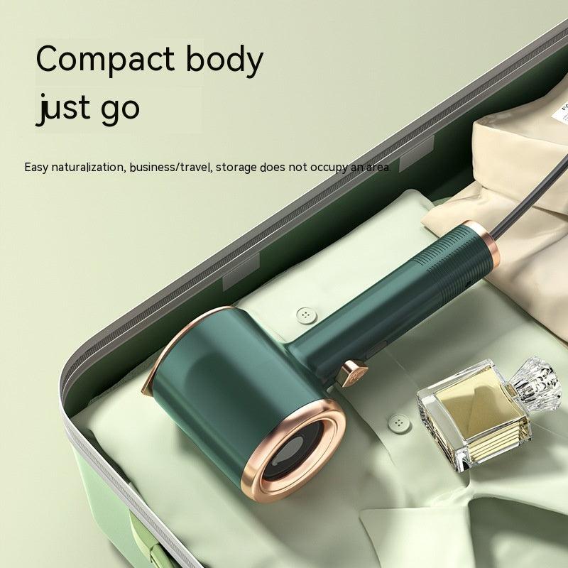 Shopi Vella compact travel clothes steamer US plug in suitcase on folded clothes