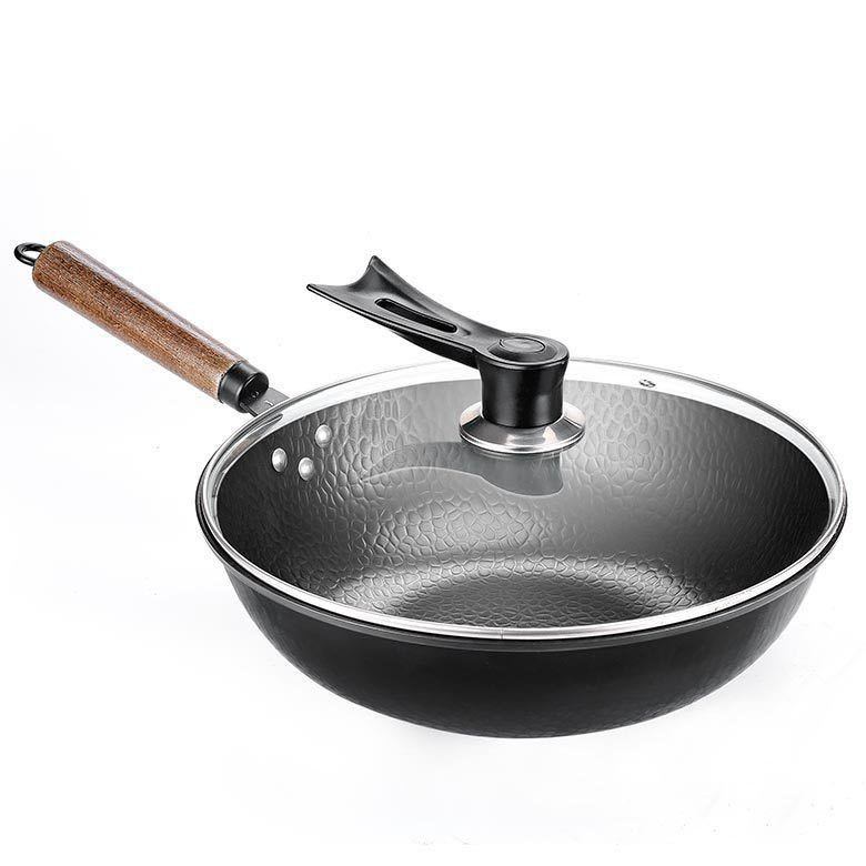Handmade iron wok with wooden handle and glass lid from Shopi Vella cooking tools