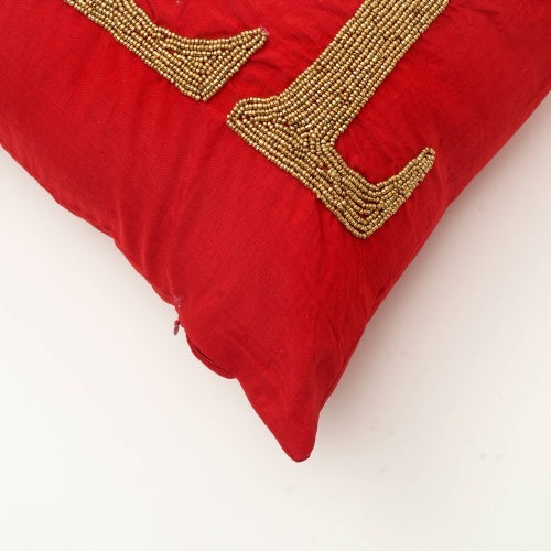 Handmade red Noel pillow case with gold bead detailing by Shopi Vella on a white background