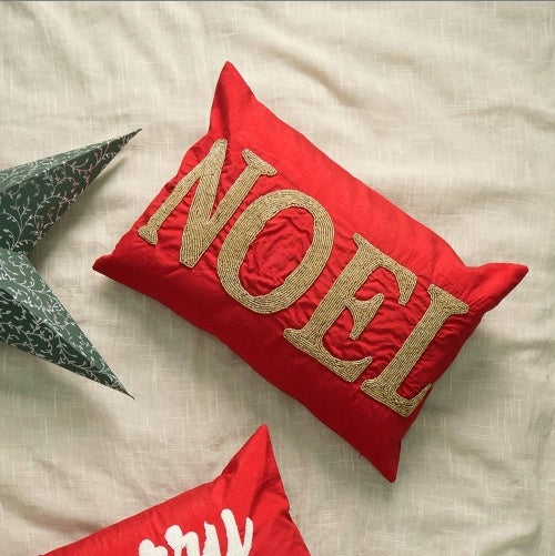 Shopi Vella handmade red Noel pillow case with gold embroidered Noel text on red fabric