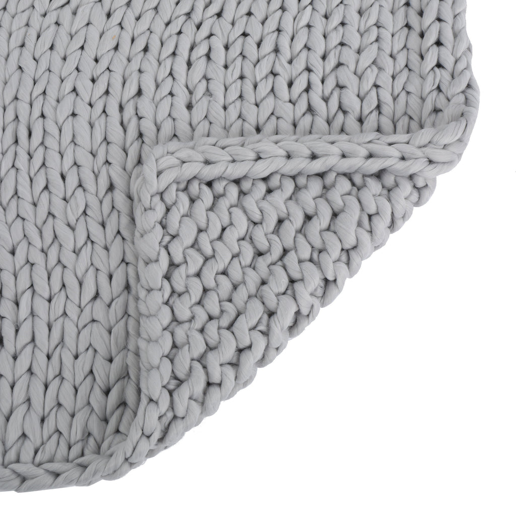Shopi Vella handwoven thick yarn blanket in light gray with chunky knit texture and folded corner
