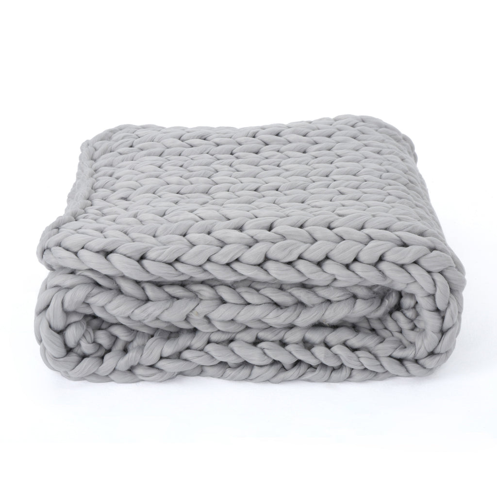 Shopi Vella handwoven thick yarn blanket folded in light gray with chunky knit texture