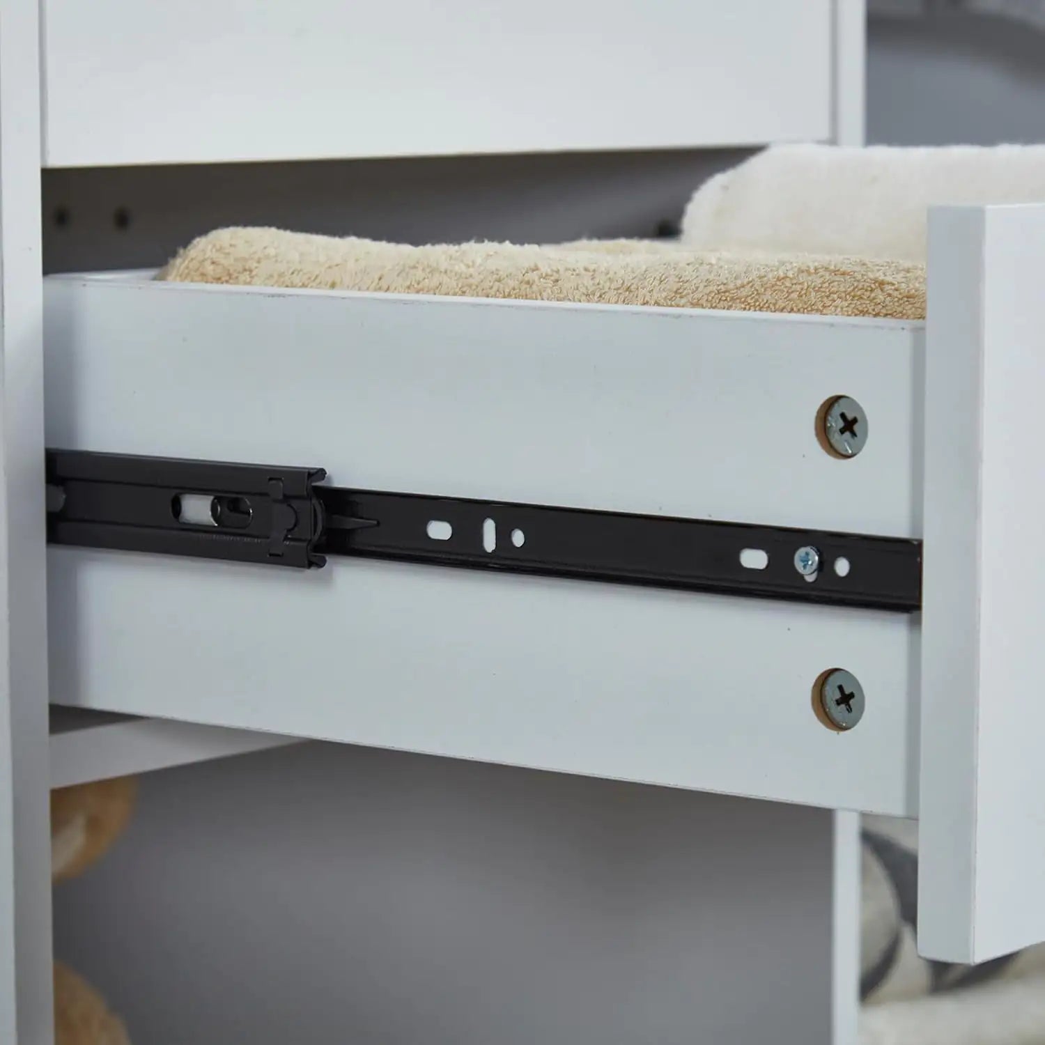 Close-up view of drawer slide mechanism in white wooden closet organizer with hanging rod closet organizer for bedroom