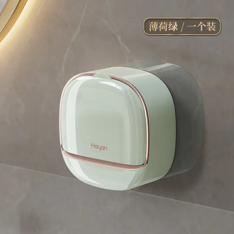 Modern wall mounted soap dish in light green with rose gold accents attached to bathroom wall