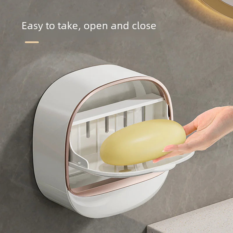 Wall mounted soap dish in white with a hand placing a bar of soap inside, easy to open and close