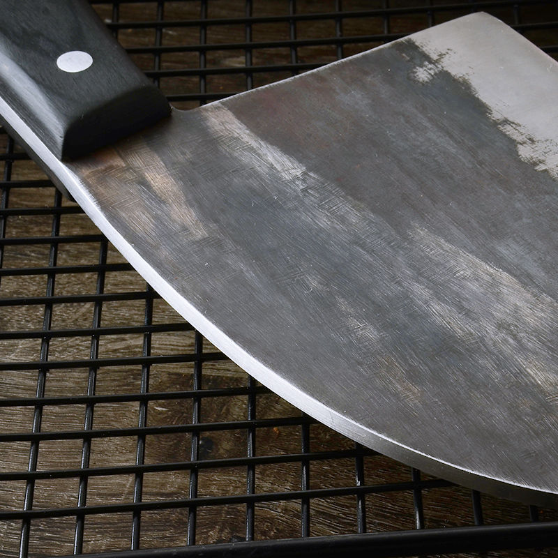 Close-up of high hardness chopping knife blade with black handle on metal rack surface