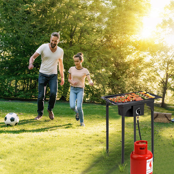 High pressure propane gas burner outdoor cooking grill with vegetables and meat on the grill