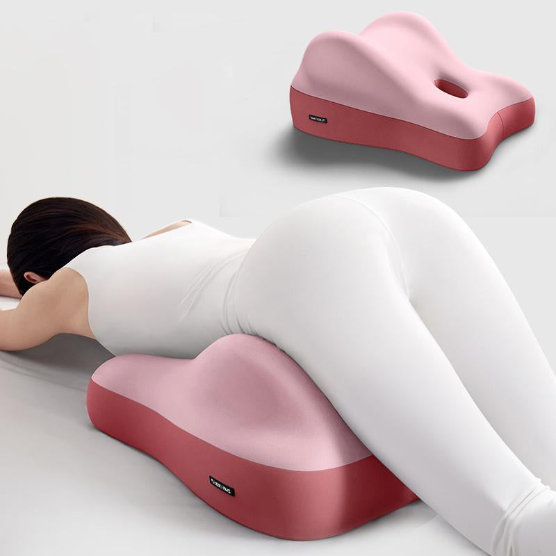 Shopi Vella hip raised sleep cushion in pink and red supporting hips of person lying face down
