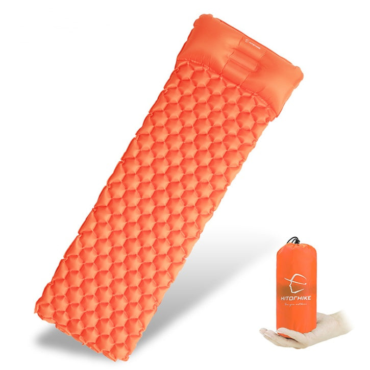 Orange inflatable camping mattress by Shopi Vella with built-in pillow and compact carrying bag