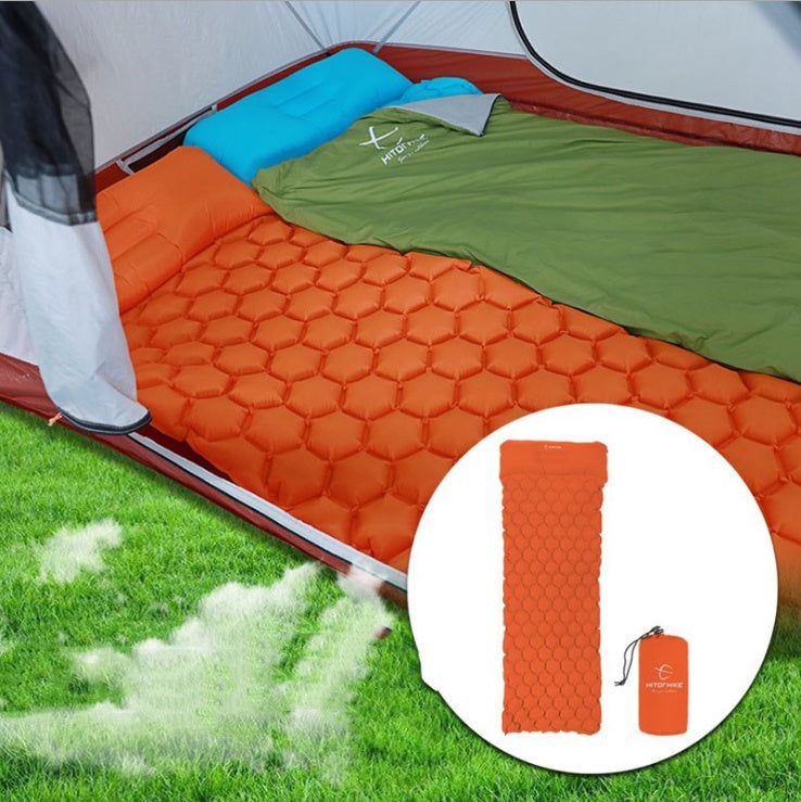 Shopi Vella inflatable camping mattress in orange with hexagonal pattern inside a tent for outdoor camping
