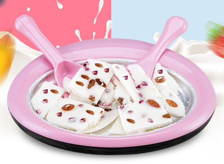 Homemade rolled ice cream machine with pink edge and creamy nut toppings ready to serve