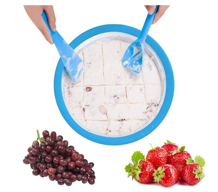 Homemade rolled ice cream machine preparing rolled ice cream with blue tools alongside fresh grapes and strawberries