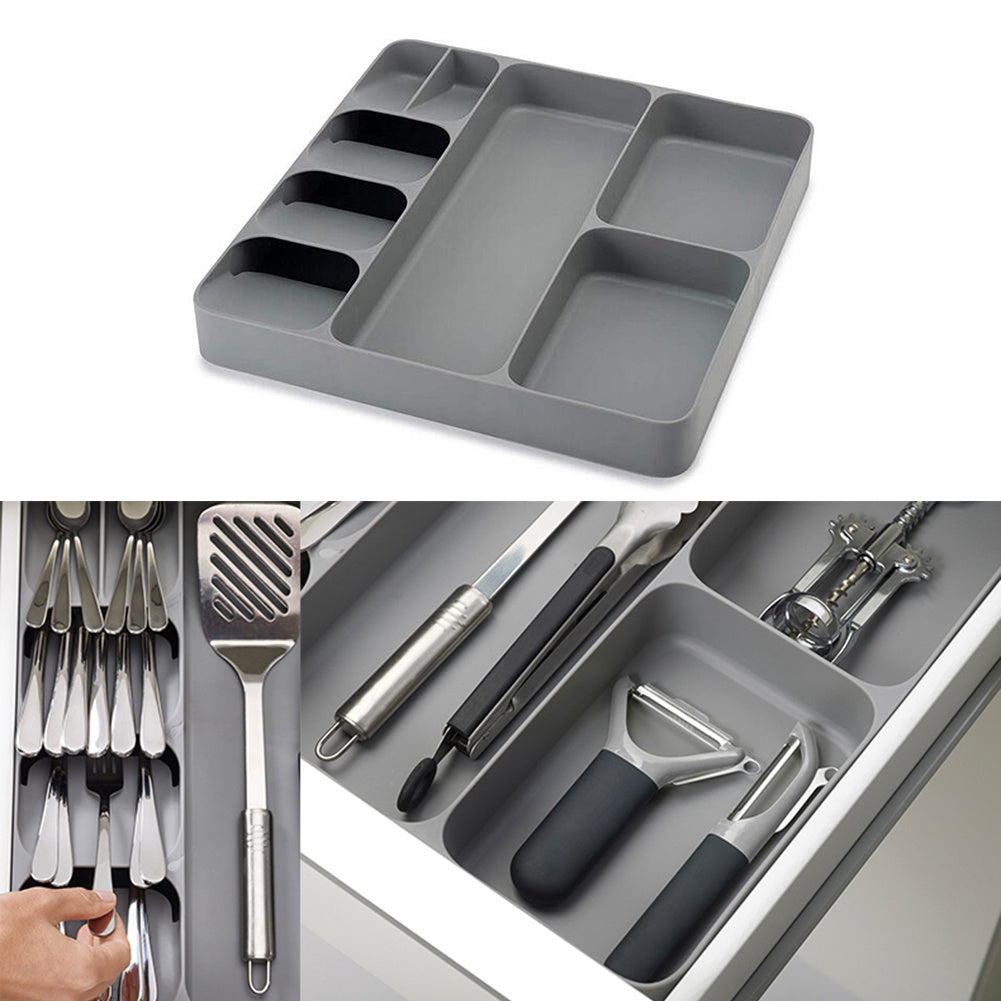 Gray kitchen utensil drawer organizer with multiple compartments for storing cutlery and kitchen tools