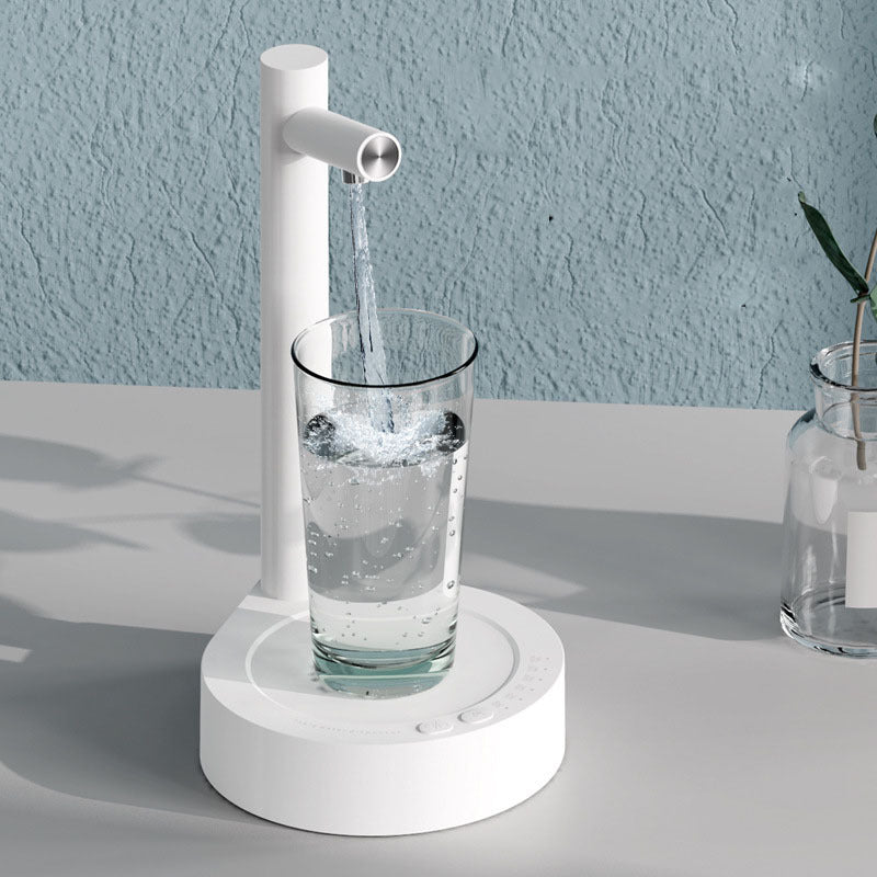 Shopi Vella sleek white desk water dispenser for office pouring water into a clear glass