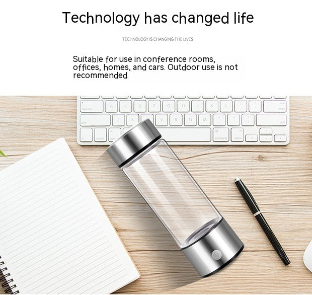 Shopi Vella hydrogen water bottle portable with silver lids on wooden desk with keyboard and notebook