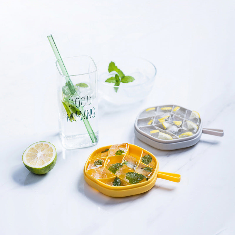 Shopi Vella 3D ice cream maker silicone molds in yellow and gray with ice cubes and mint leaves