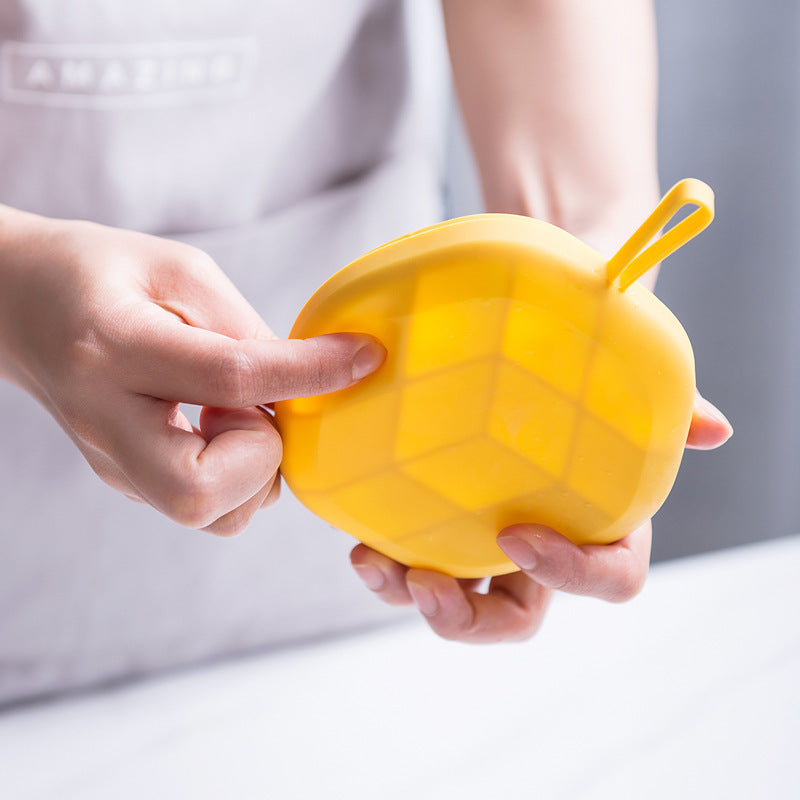 Person holding bright yellow 3D ice cream maker silicone in hands with flexible silicone texture