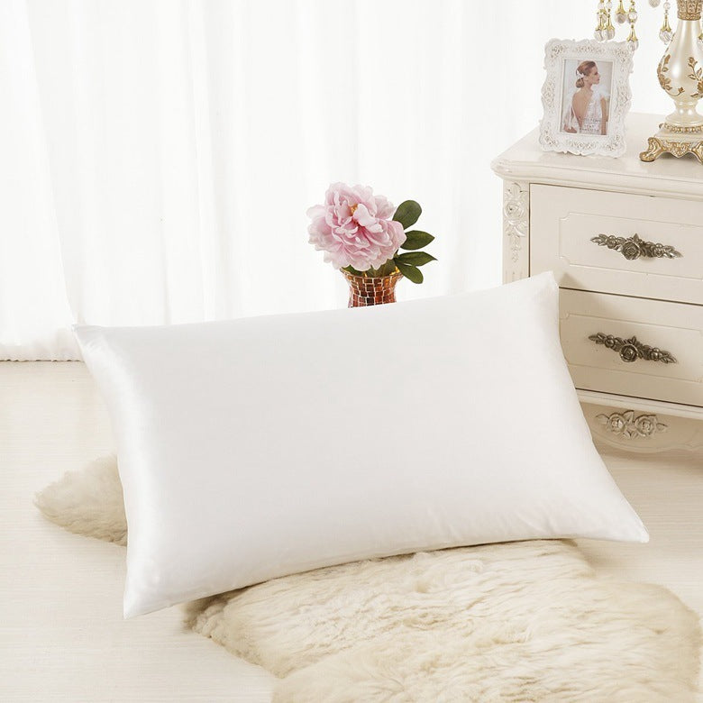Shopi Vella white ice silk single pillowcase placed on a soft rug in a bright bedroom