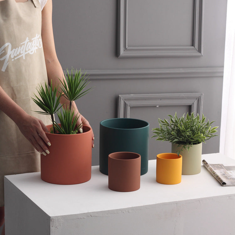 Shopi Vella industrial style planter pot set with various sizes and colors on white table