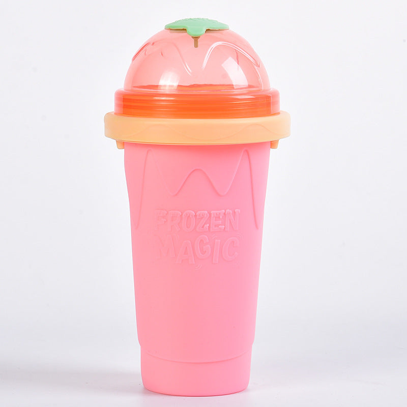 Shopi Vella instant frozen drink cup in pink with orange lid and green top for frozen beverages