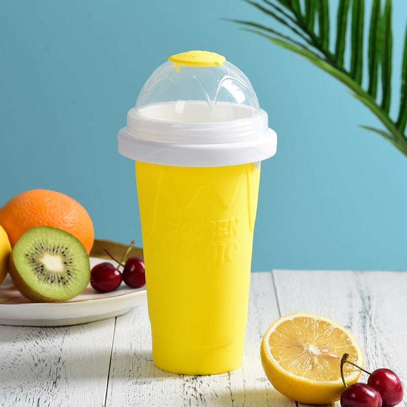 Shopi Vella yellow instant frozen drink cup with clear lid on white wooden table with fruit background