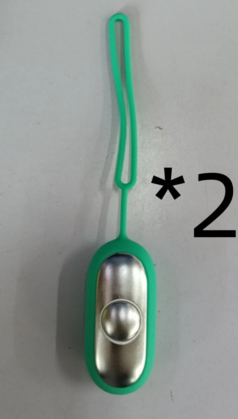 Shopi Vella intelligent sleep therapy device in green with a metallic button and flexible loop for easy handling