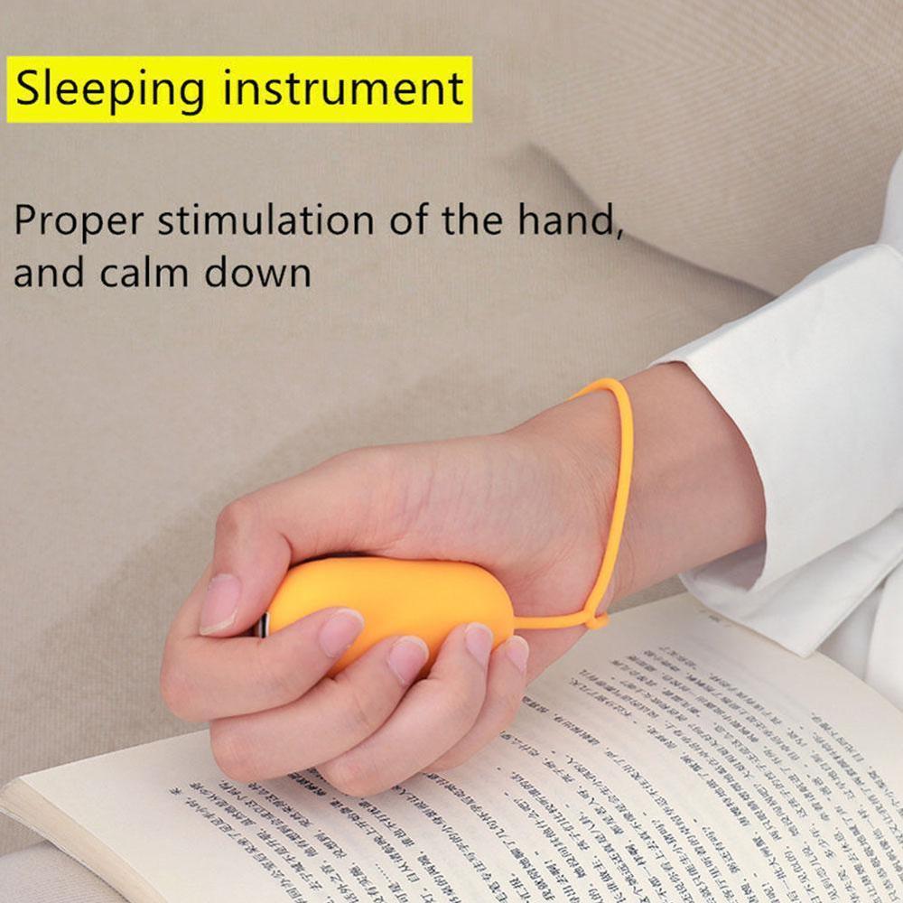 Hand holding yellow intelligent sleep therapy device for proper hand stimulation and relaxation