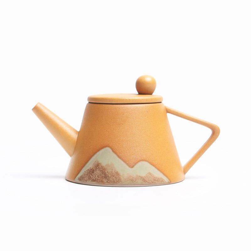 Shopi Vella Japanese ceramic teapot with orange matte finish and mountain design on the body