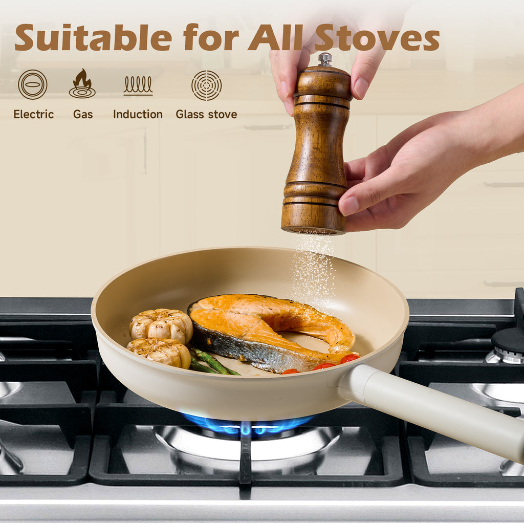 Healthy induction cookware with removable handles cooking salmon and vegetables on gas stove