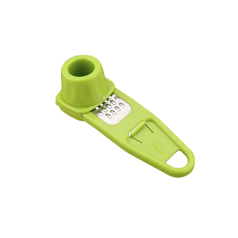 Green garlic masher kitchen tool with stainless steel grater and ergonomic handle