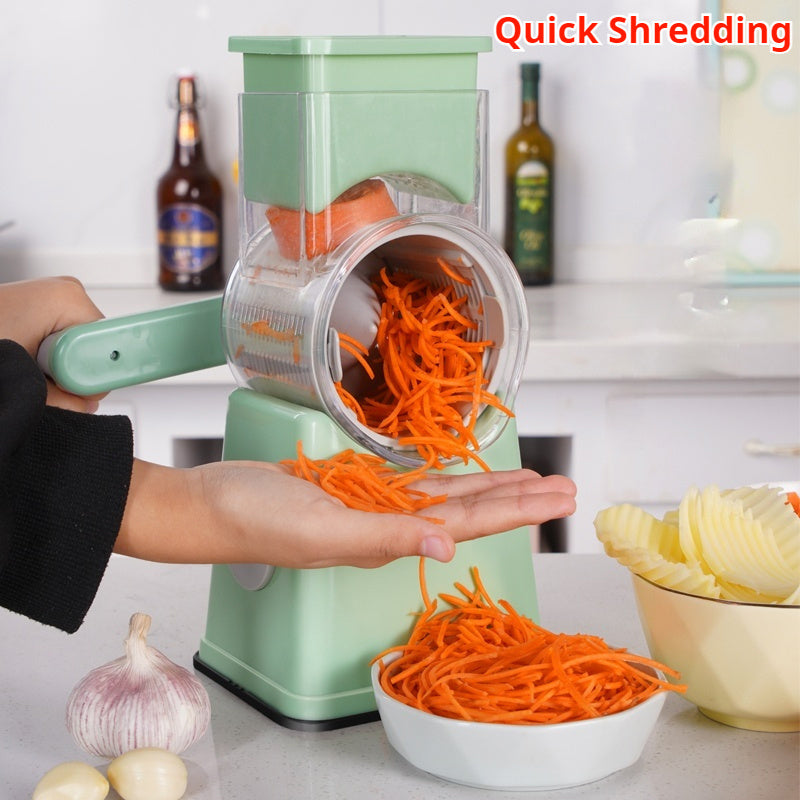 Shopi Vella kitchen vegetable slicer shredding carrots into thin strips with a green hand-crank design