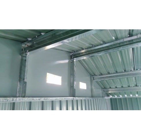 Interior view of Shopi Vella large outdoor storage shed showing metal framing and ventilation windows