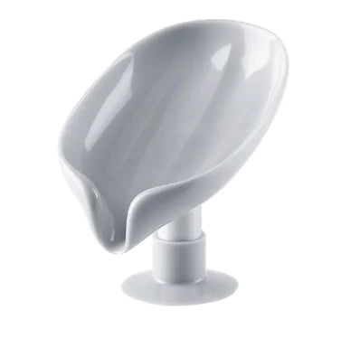White ceramic leaf shaped soap holder with smooth glossy finish and pedestal base