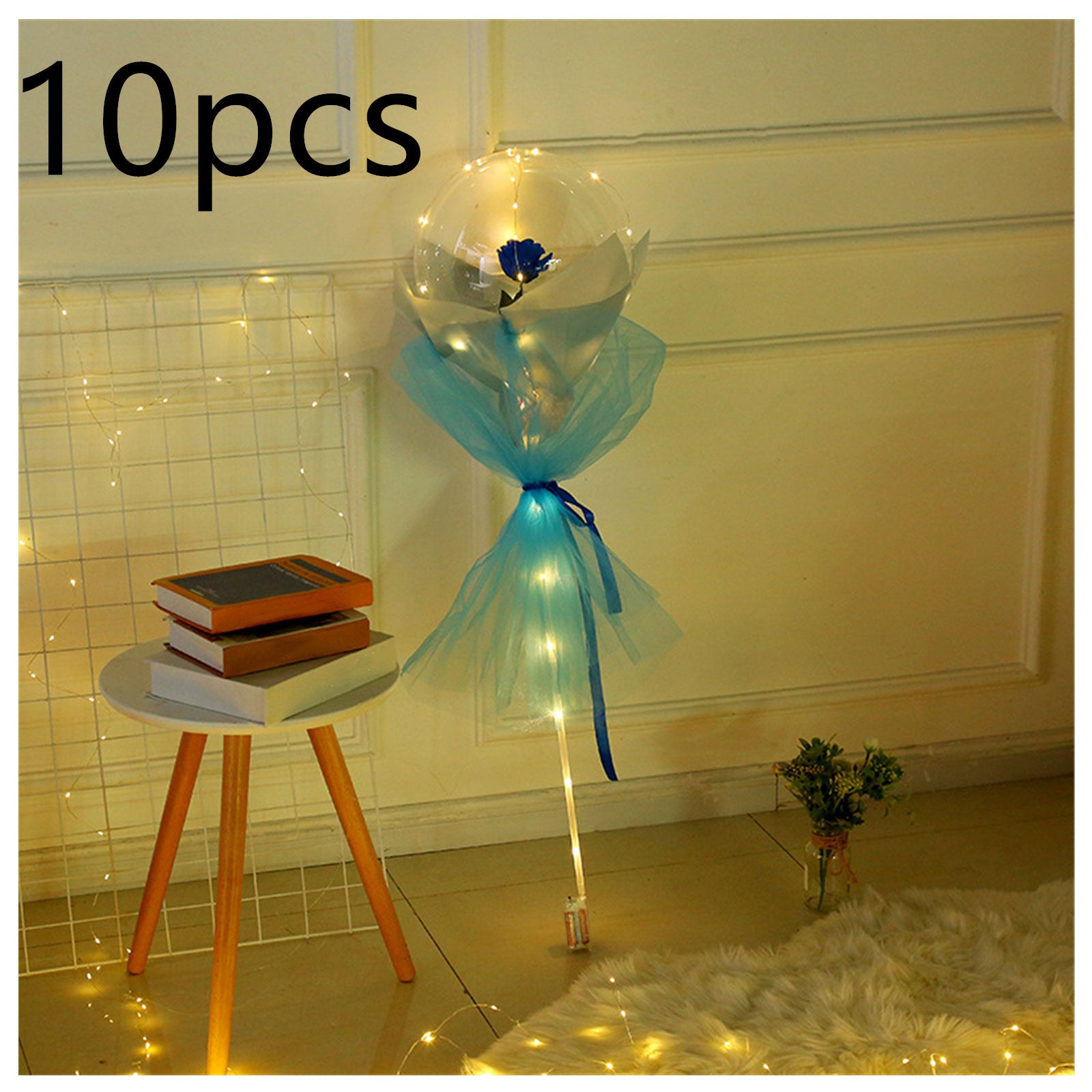 LED rose balloon bouquet with blue rose and tulle wrap displayed indoors with fairy lights
