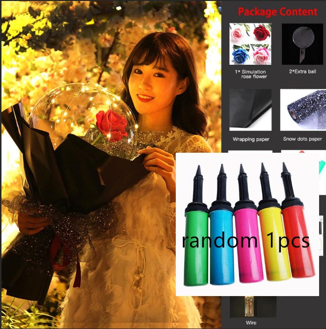 Woman holding LED rose balloon bouquet wrapped in black paper with decorative glitter ribbon
