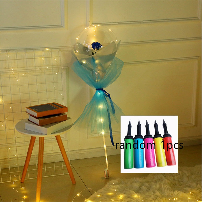 Shopi Vella LED rose balloon bouquet with blue rose and blue tulle wrap near wooden stool with books