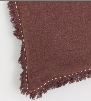 Shopi Vella linen pillow with fringe edges in deep brown color close-up view