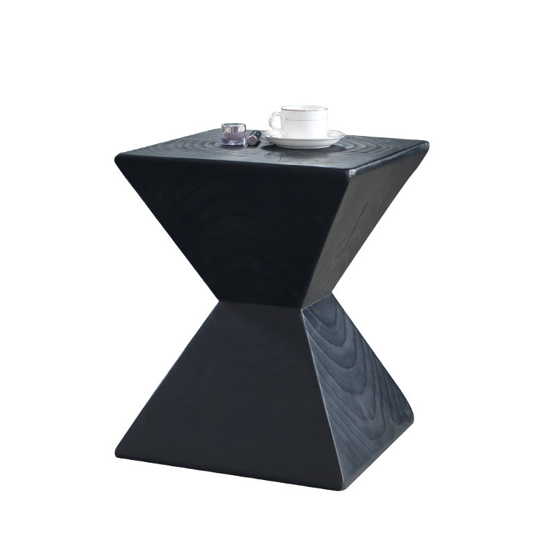 Shopi Vella black geometric log sofa side table with a cup and candle on top